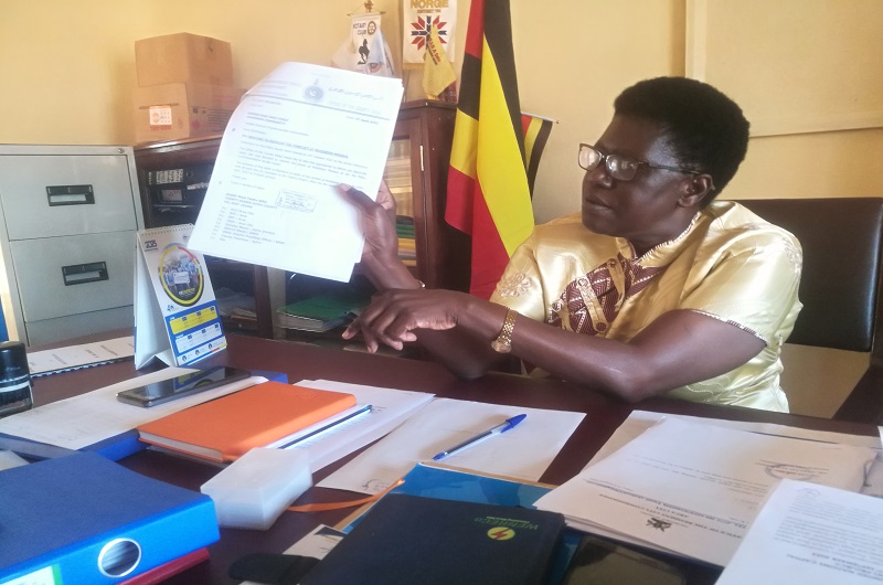 RCC Akello displays one of the letters concerning Muhibeen mosque saga in her office on Tuesday. Photo by Andrew Cohen Amvesi