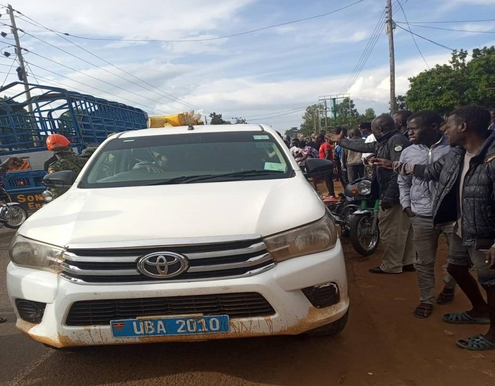 Locals while fuming on URA enforcement officers at the accident scene on Tuesday. COURTESY PHOTO