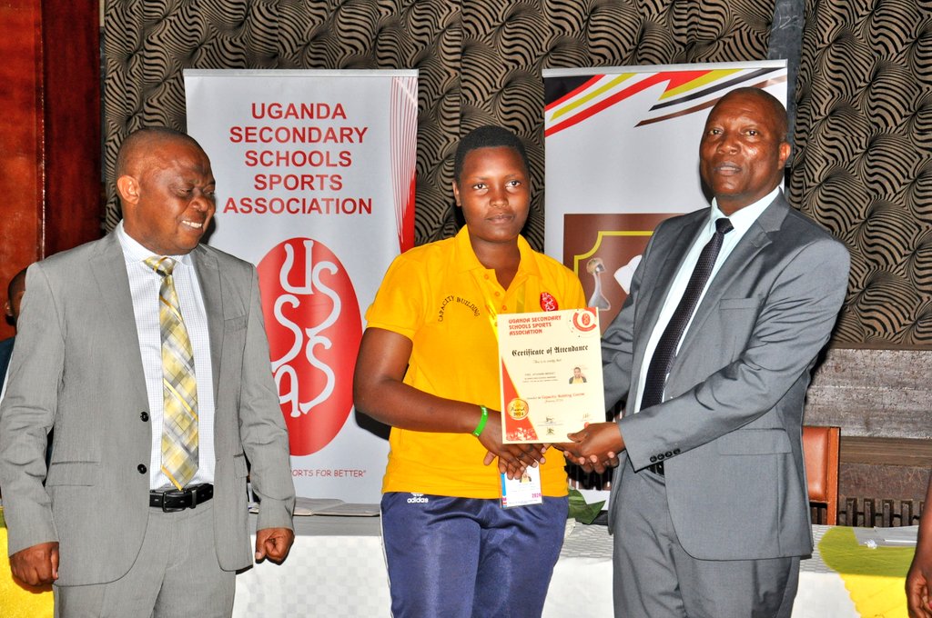 best participant receiving her certificate from Chief Guest at Kibuli
