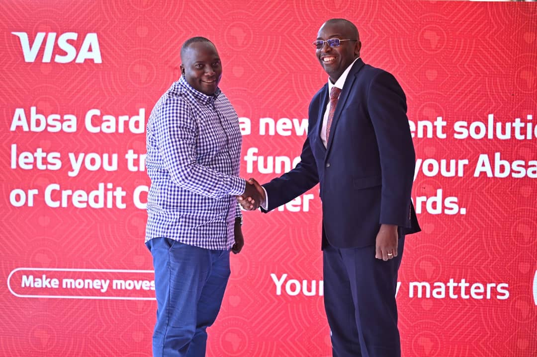 Eric Baleteirewa (left), named the overall winner of the 'Win your ticket to Glory' campaign, poses for a photo with Absa Bank's Chief Finance Officer, Michael Segwaya