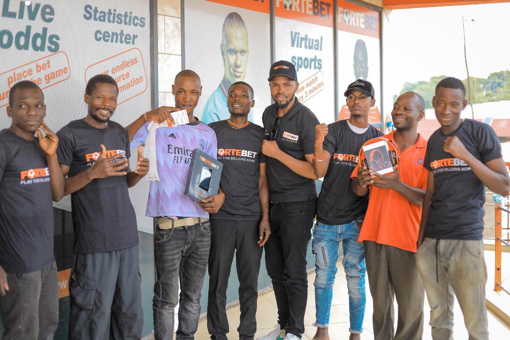 Busula T-shirts, phone and headsets winners in a group phpto with Muhangi