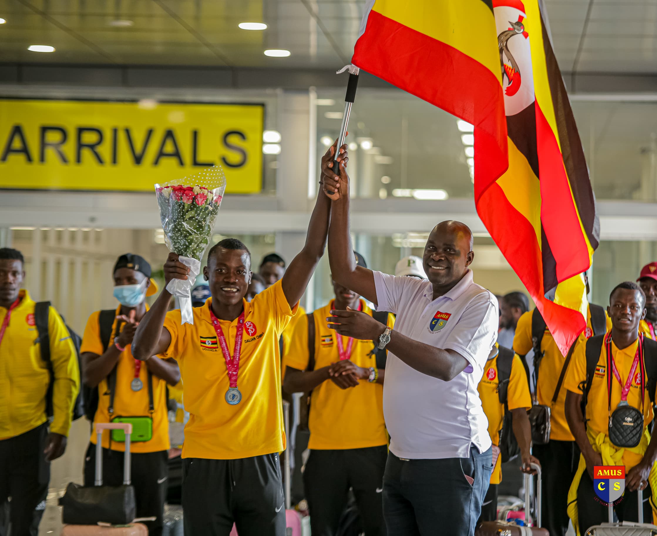 Pop and Jubilation at Entebbe Airport as Amus College School’s Silver Medalists jet in