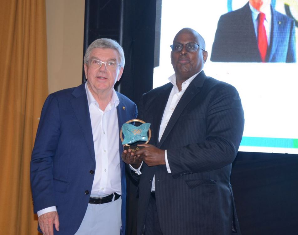 Dr. Thomas Bach awards IOC President’s trophy to Dr. Donald Rukare, UOC President